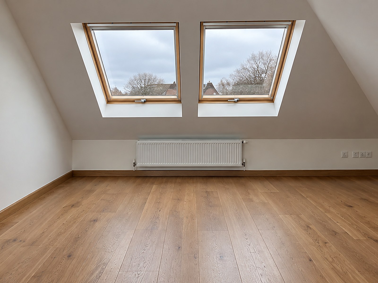 Completed loft room with roof windows — Twin roof windows, new plasterboard, oak flooring and matching skirting